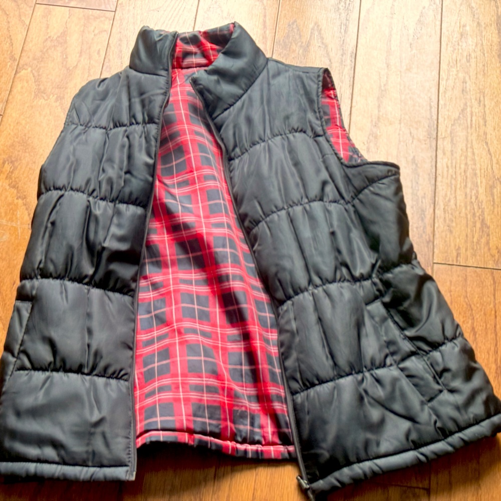 Black vest with plaid interior. Can be reversed.
